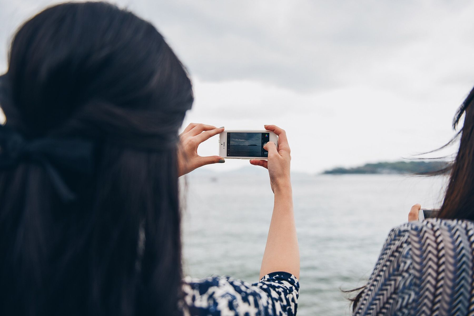 A woman taking a picture with her phone