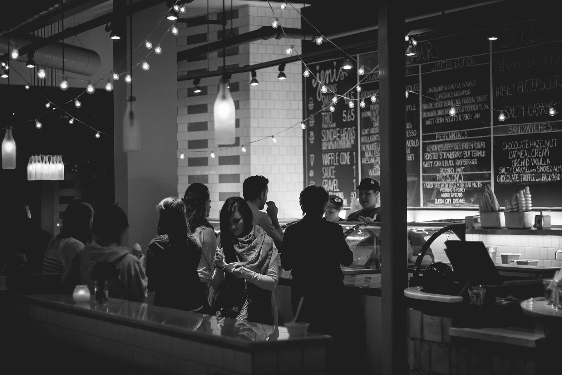 Customers at the counter of a busy café
