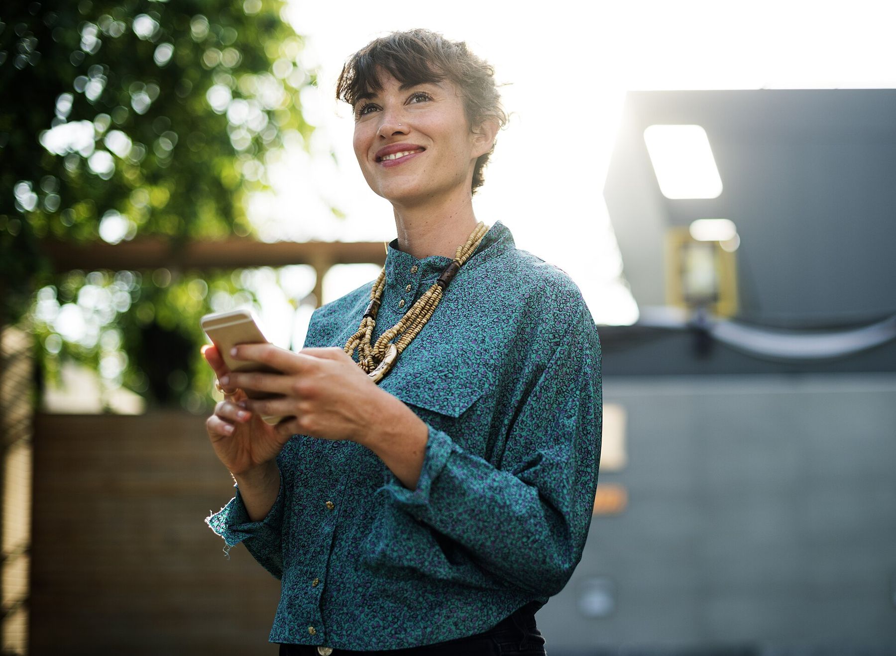A woman smiling at her phone